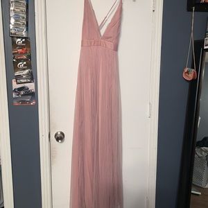 It’s a pink long dress it’s straps and cross from the back it had 2 slips